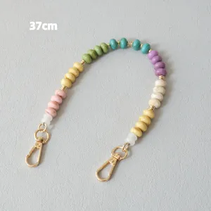 Close-up of a 37cm colorful acrylic bead strap with gold lobster clasps for bags
