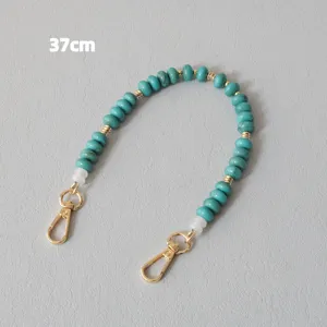 Close-up of 37cm turquoise acrylic beaded chain with golden metal lobster clasps
