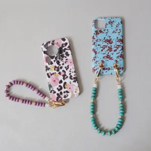 Close-up of candy-colored acrylic beaded straps attached to patterned phone cases