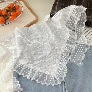 Detailed close-up of white lace floral triangle scarf, sweet ruffle net edge.