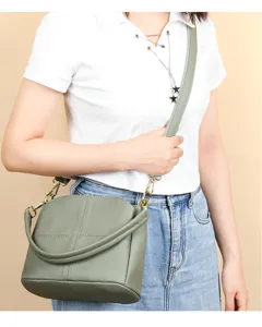 Detailed view of women's genuine leather bucket bag, soft cowhide shoulder bag with hardware.