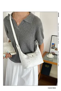 Sac à bandoulière blanc en forme de croissant avec des motifs d'étoiles argentées