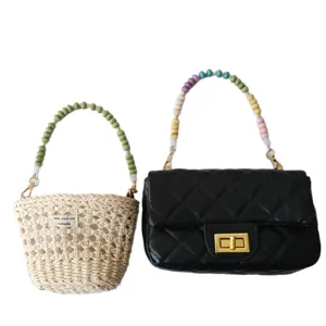 Two stylish handbags featuring vibrant acrylic beaded chain straps on plain white background