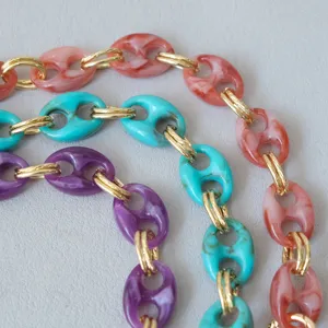 Close-up detail of colorful retro resin pig-nose chain straps for bags and phone accessories
