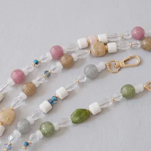 Detailed close-up of a colorful acrylic beaded chain featuring a gold-tone lobster clasp