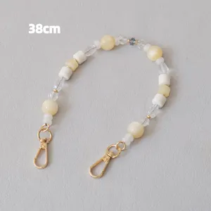 Detail view of a 38cm acrylic bead chain featuring cream and transparent resin beads