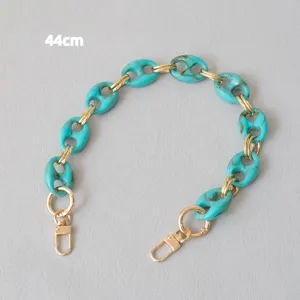 Close-up of 44cm turquoise resin pig nose chain strap with gold clasps for bags.