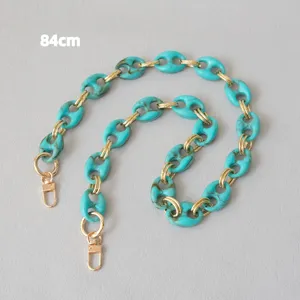 Detail view of turquoise marble resin pig nose chain strap with gold links, 84cm