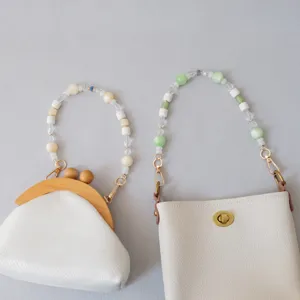 Close-up of fashionable acrylic and resin beaded straps for bags in green and white colors