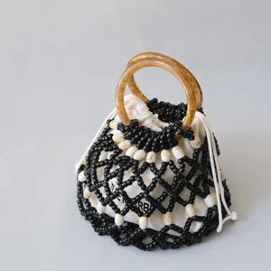 Detalle de las asas de resina ámbar en un bolso de cuentas con cordón de estilo retro