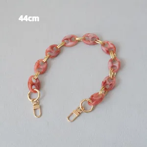 Detail view of 44cm pink marble resin chain strap with elegant gold metal clips