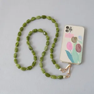 Detail van groene acryl kralenketting verbonden met een bloemmotief telefoonhoesje
