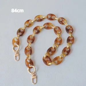 Detailed view of retro amber pig nose resin chain strap with gold lobster clasps