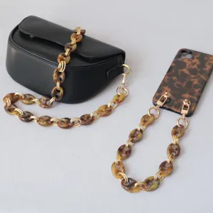 Detailed view of tortoiseshell resin chain strap used on bag and phone case
