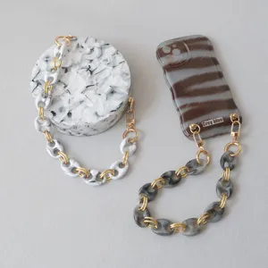 Close-up detail of marbled resin pig nose chain for retro phone cases and bags