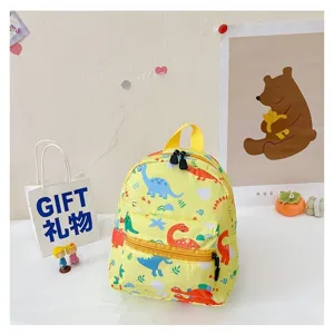 Detailed view of yellow toddler backpack with colorful cartoon dinosaur prints