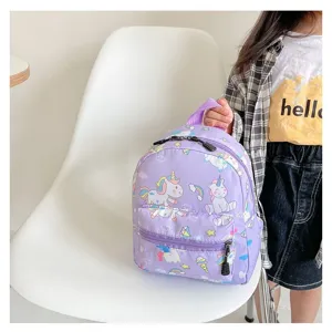 Detailed view of the cute purple unicorn cartoon backpack being held by a young girl