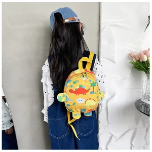 Back view of a child wearing a cute yellow dinosaur patterned backpack.