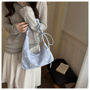 Light blue gingham underarm bag with white bow prints and ruffled handle detail