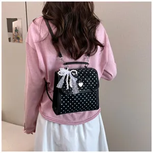 Stylish sweet black and white polka dot backpack with lace and pearl charms detail