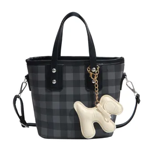Modern grey and black checkered bucket bag for women featuring a cute puppy charm accessory