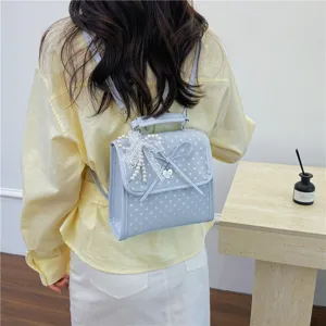 Sweet light blue polka dot backpack with delicate lace bow and pearl charm accents
