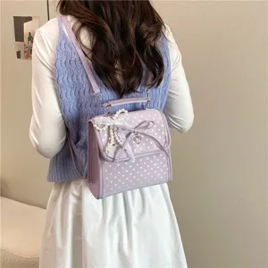Korean style sweet purple polka dot backpack featuring lace bow and pearl charm decorations