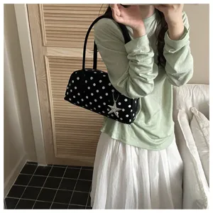 Stylish black and white polka dot pillow shaped handbag with a cute star charm accessory