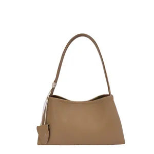 Minimalist tan leather underarm tote bag for women featuring a unique knotted handle design