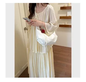 Elegant white pleated dumpling hobo underarm bag featured in a stylish lifestyle model photo