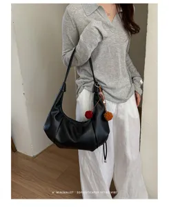 Minimalist retro black hobo dumpling shoulder bag styled with a casual outfit on a model