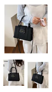Black leather fashion tote bag shown carried by a model in a lifestyle setting