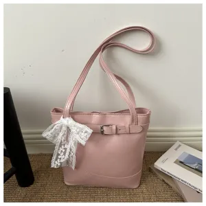 Dettaglio della borsa a secchiello in ecopelle rosa con cintura e fiocco