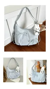 Detailed view of light blue bow tote bag with a cute white plush rabbit charm accessory