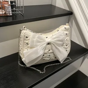 Chic white bubble gauze underarm bag featuring a large satin bow and silver chain strap.