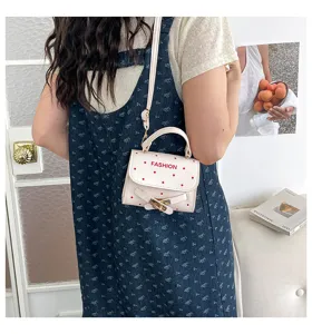 Cute white polka dot mini square handbag with adjustable shoulder strap for stylish women