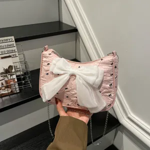 Detailed view of pink bubble gauze shoulder bag featuring a large white decorative bow