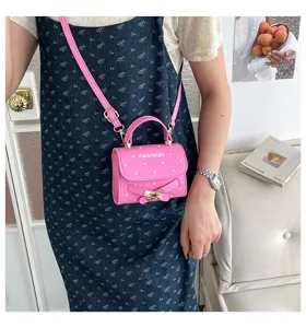 Close-up of the stylish pink polka dot mini crossbody bag with gold buckle closure