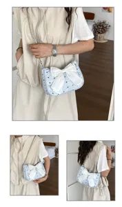 Light blue seersucker shoulder bag with a large white bow shown on a female model.