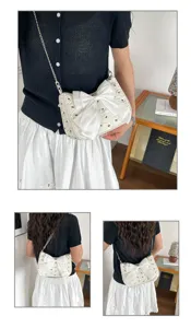Detail view of the white seersucker bowknot shoulder bag with elegant chain strap