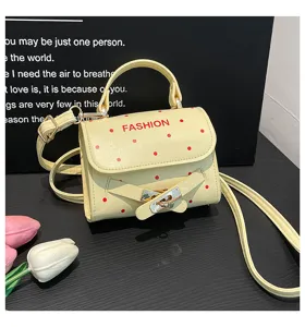 Pale yellow polka dot small square handbag with belt buckle and crossbody strap