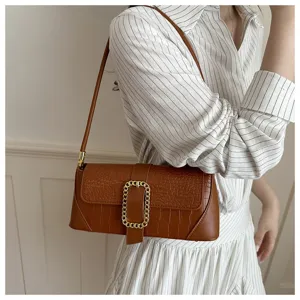 Brown stone pattern baguette underarm bag on model for casual chic style