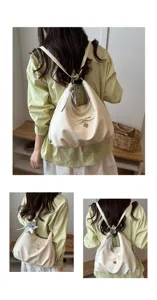Model wearing cream multifunctional crescent backpack with bow and star charm detail
