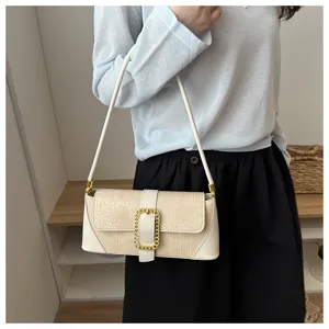 Close-up detail of a cream baguette shoulder bag featuring elegant stone pattern texture