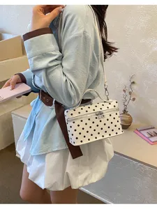 Stylish white polka dot box handbag shown on a model for a trendy Korean-inspired look