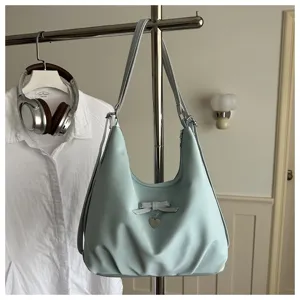 Stylish light blue large capacity hobo bag with elegant bow and heart pendant detail