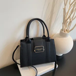 Elegant black leather tote bag with gold buckle for stylish daily commute and office use