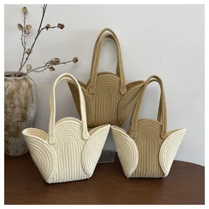 Detailansicht von drei gewebten Tulpen-Einkaufstaschen in Beige und Camel-Farben.