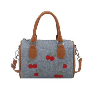 Stylish denim handbag with red cherry embroidery and brown handles, large capacity