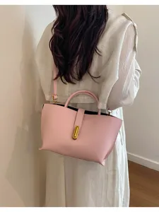 Bolso tote de cuero rosa con grano de litchi usado como bandolera, vista posterior